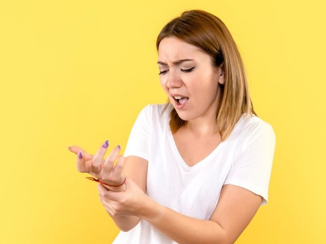 Concerned woman examining bug bite